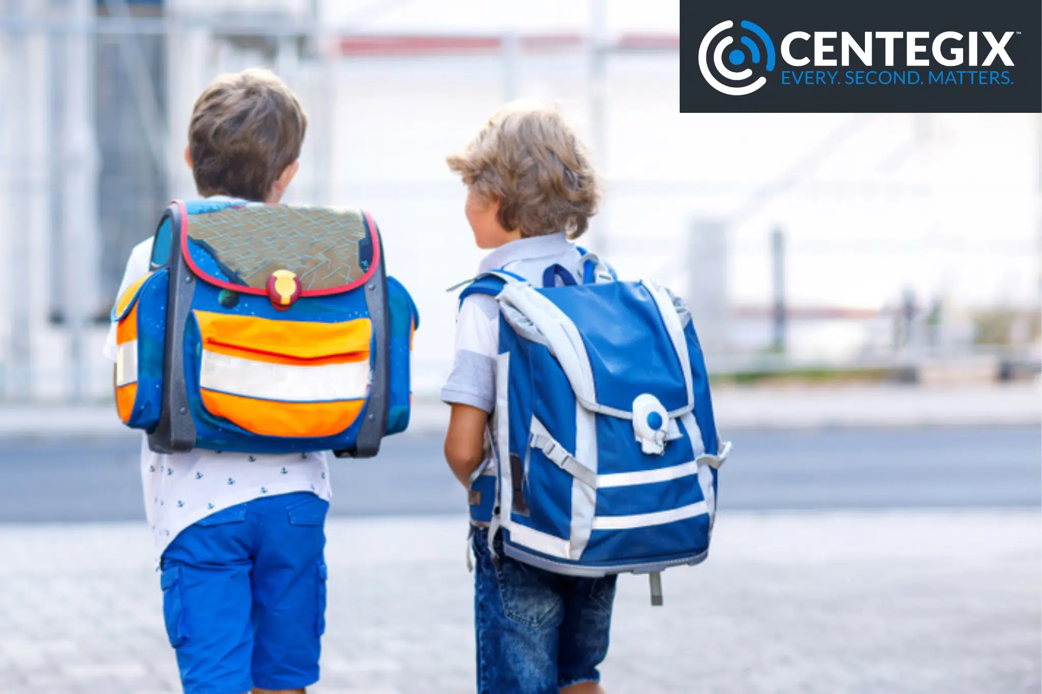 Two young boys wearing backpacks walking outside, safer because of CENTEGIX wearable emergency button