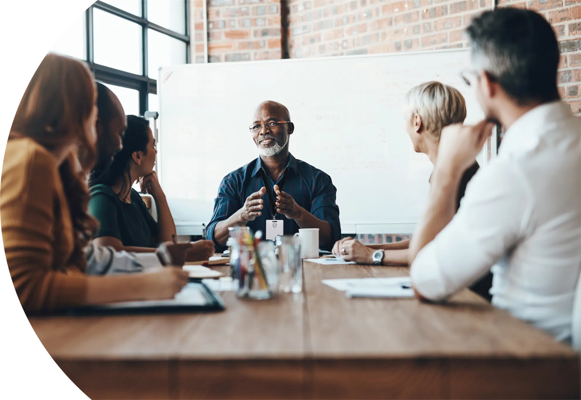 Adults sitting around a desk working together